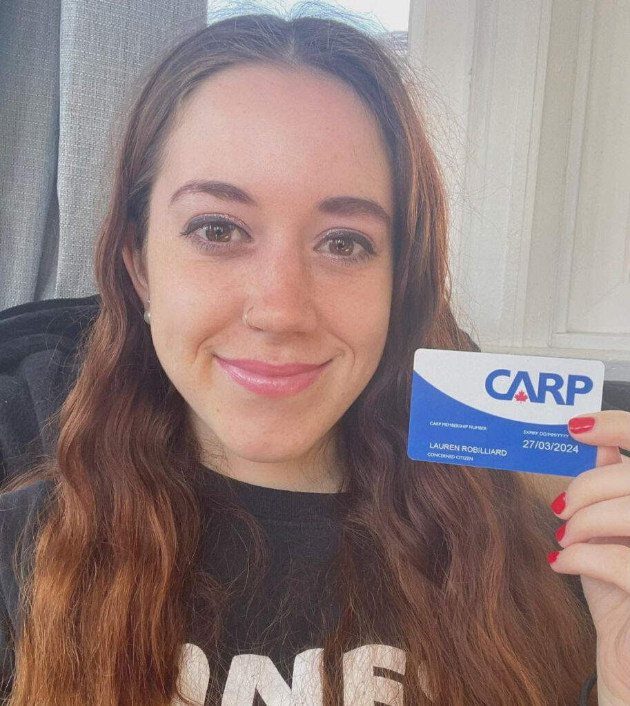 Media and Marketing Manager Lauren holds up her CARP membership card.